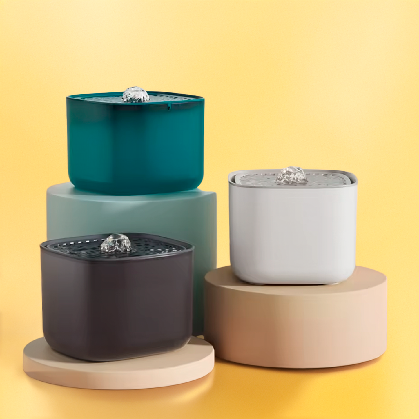 Three cylindrical pet water fountains in teal, gray, black, and beige on a yellow background.